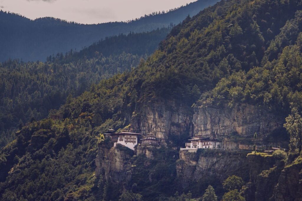 The famous Tiger's Nest Monastery perched on a cliffside in Bhutan's lush mountains.