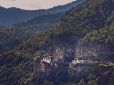 The famous Tiger's Nest Monastery perched on a cliffside in Bhutan's lush mountains.