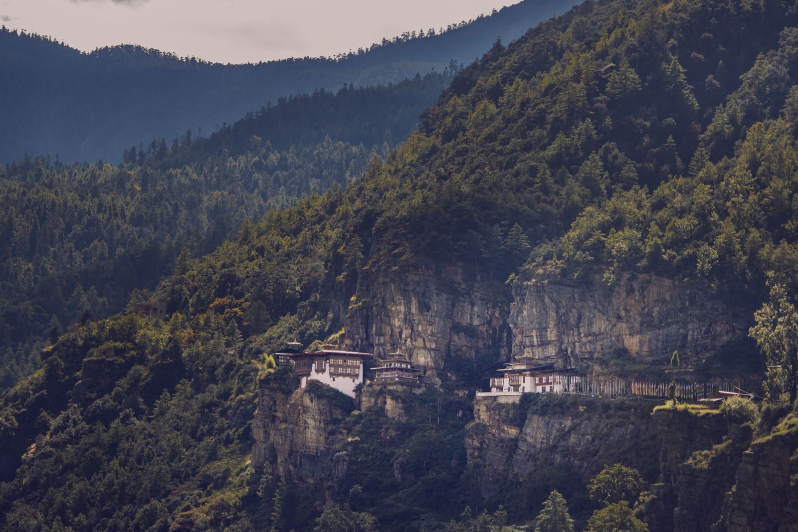 The famous Tiger's Nest Monastery perched on a cliffside in Bhutan's lush mountains.
